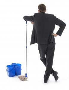 Cleaning up the mess. Businessman with bucket and rag.